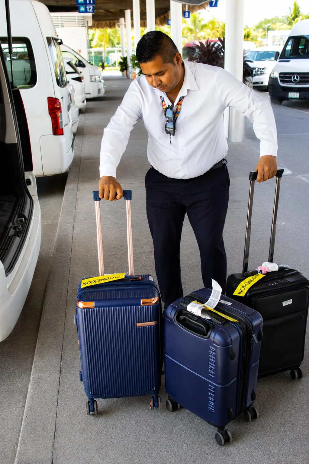 Conductor de Huatulco Transfers recibiendo el equipaje del cliente en el aeropuerto HUX